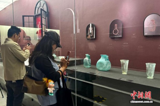 游客市民在庞贝文物展中拍照记录。 罗婕 摄